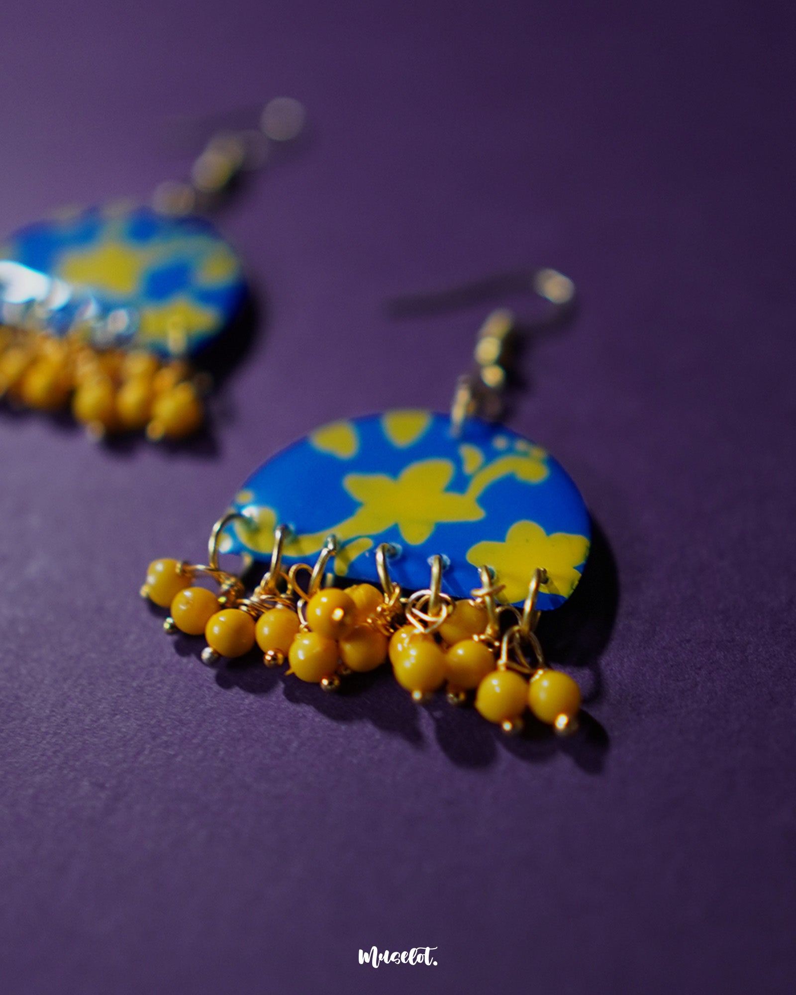 Mahrosh floral hook earrings, set against a soft, neutral background, with detailed floral motifs and delicate craftsmanship that highlight their graceful elegance and natural beauty — Muselot.
