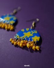 Mahrosh floral hook earrings, set against a soft, neutral background, with detailed floral motifs and delicate craftsmanship that highlight their graceful elegance and natural beauty — Muselot.