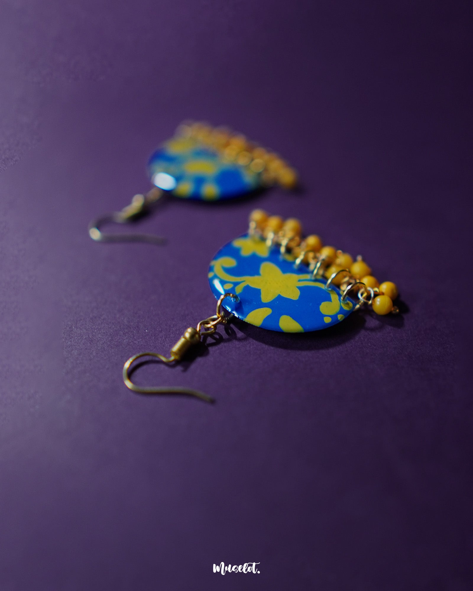 Mahrosh floral hook earrings, placed against a gentle background, with beautifully crafted floral patterns and intricate detailing that evoke a sense of delicate elegance and timeless charm — Muselot.