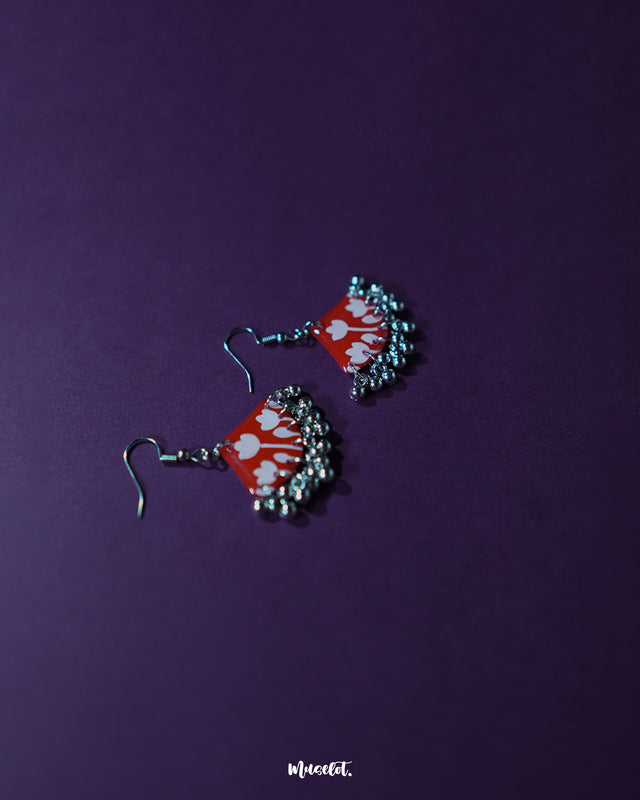 The Meherbaan red floral hook earrings highlighting the intricate petal work and handcrafted finish, designed to bring a burst of elegance to any look — Muselot.