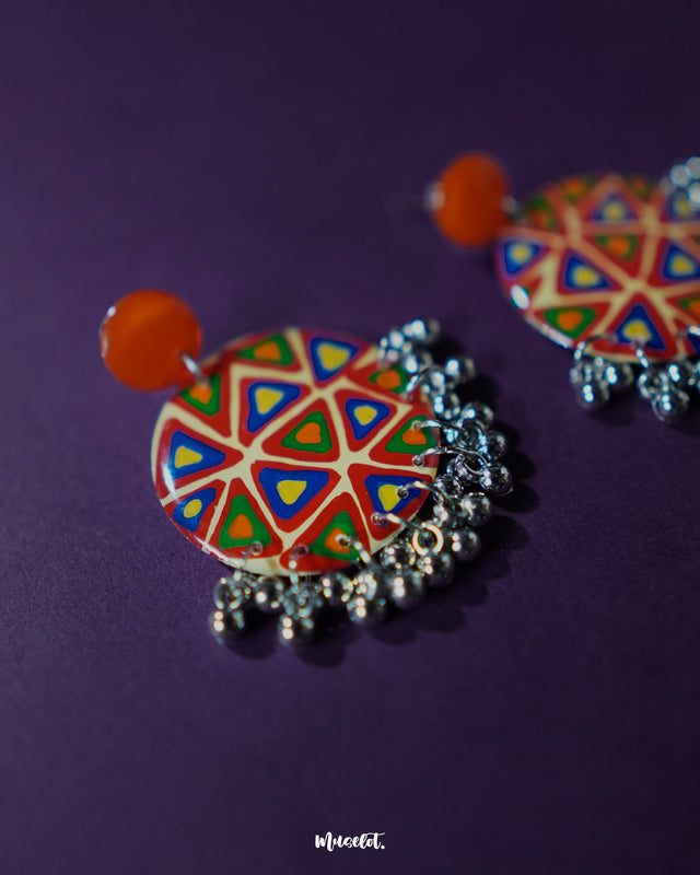 Multi-color Chakardi traditional earrings, displayed against a soft-toned backdrop, with vibrant colors and finely crafted patterns that capture the essence of traditional artistry with a modern touch — Muselot.