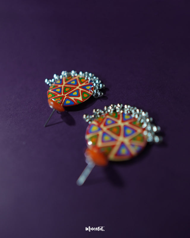 Chakardi traditional earrings, set against a subtle backdrop, featuring bold, vibrant colors and intricate detailing that exude cultural charm and timeless elegance — Muselot.