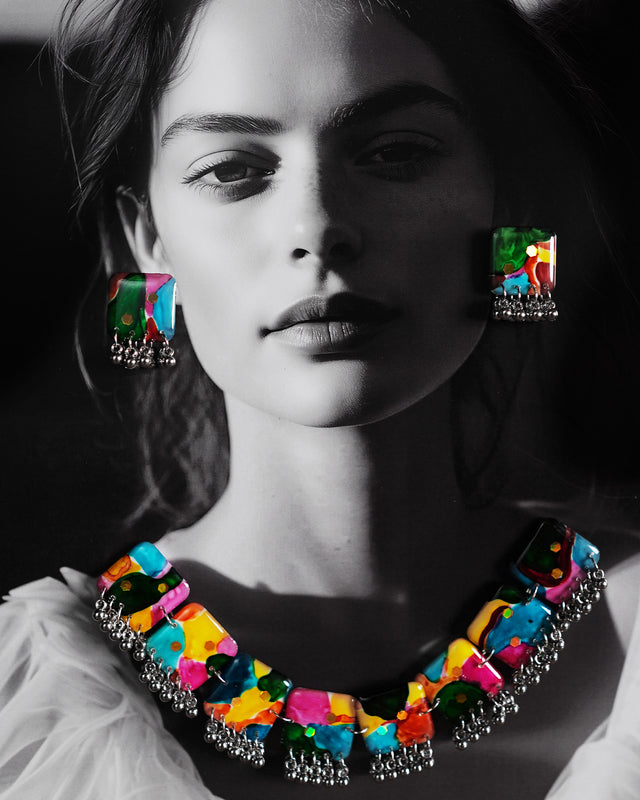 A model wearing the multicolor boho necklace set from Muselot, styled over a solid-toned outfit. The necklace’s vibrant beads and eclectic design stand out, adding a playful and artsy flair that draws attention to the neckline — Muselot