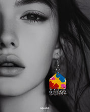 A close-up of a model wearing the Jharokhe multicolor floral earrings, highlighting the vivid floral patterns in yellow, red, blue, and pink, with delicate silver ghungroos swaying at the bottom, capturing a cheerful and artistic vibe — Muselot