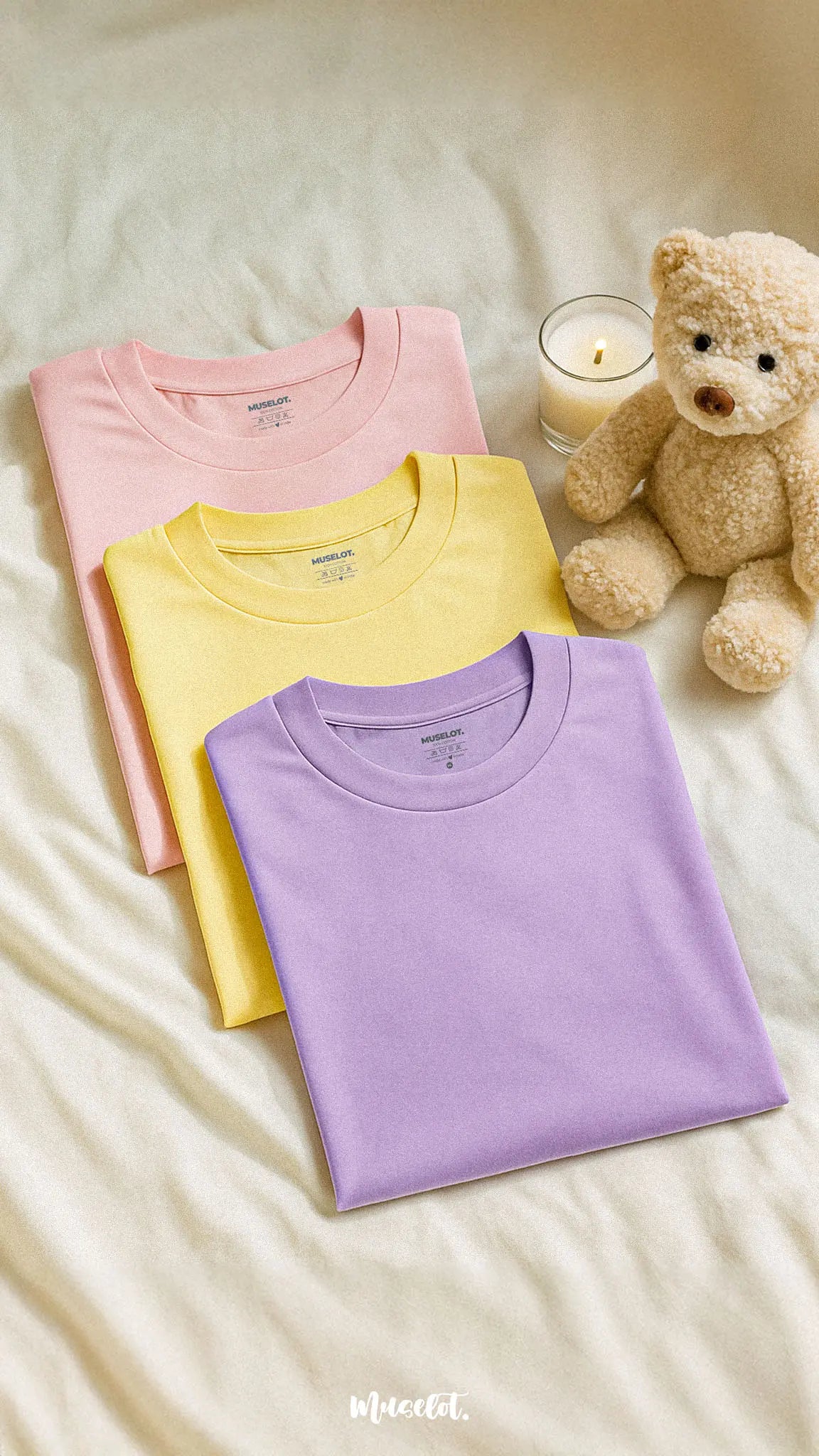 Three soft cotton unisex T-shirts in lilac, butter yellow, and baby pink, laid out neatly against an aesthetic background, showcasing their soothing pastel tones, breathable lightweight fabric, and charming cutecore appeal — Muselot