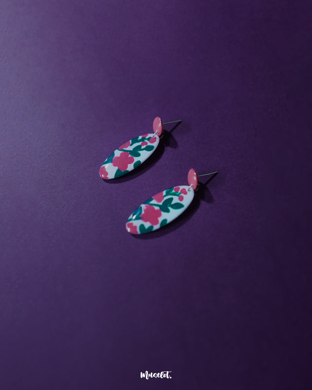 Nargis pink floral drop earrings placed aesthetically, showcasing the delicate petal structure, soft pink color palette, and artisanal charm — Muselot.