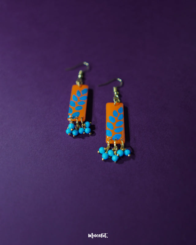 Narmshaam handmade hook earrings captured in a close-up shot on a neutral backdrop, showcasing the fine thread detailing and lightweight design that blends traditional craft with a modern, minimalist aesthetic — Muselot.