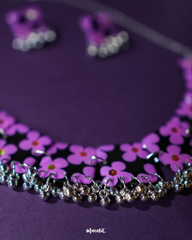 A captivating image of the Naubahar handmade purple necklace set, showcasing its intricate design with delicate lavender flowers. The rich tones of the purple in the necklace complement the floral details, creating an elegant and sophisticated aesthetic. The piece is styled to perfection, offering a harmonious balance of nature-inspired beauty and craftsmanship — Muselot