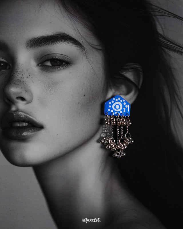 Close-up of model wearing Nazafar blue handcrafted earrings, highlighting the white circular design and cascading silver ghungroo chains – Muselot.