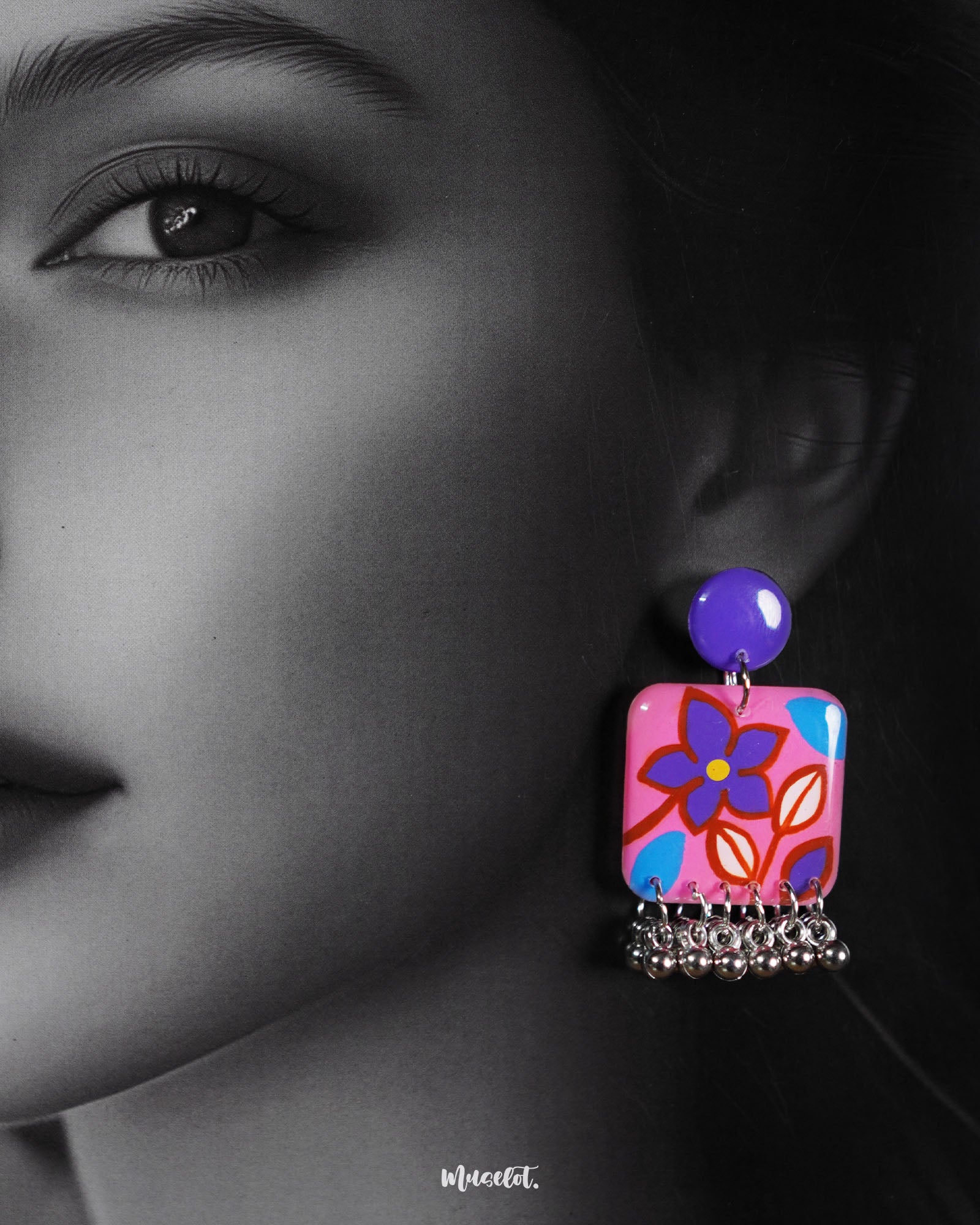 Close-up shot of a model wearing Nazmira floral stud earrings, with soft floral details and subtle earth tones, beautifully accentuating the boho-chic charm of the design — Muselot.