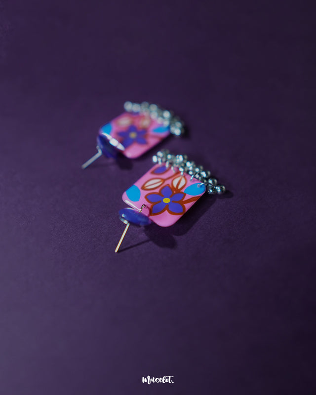 Nazmira handmade floral stud drop earrings, highlighted against a dark purple backdrop, with detailed floral studs and a graceful drop that perfectly embody bohemian elegance and artisanal craftsmanship — Muselot.