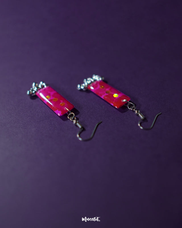 Noorasa drop earrings with a delicate shimmer, set against a deep background highlighting their refined craftsmanship and graceful allure – Muselot
