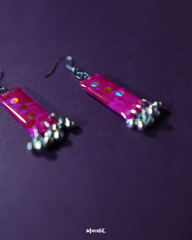 Noorasa drop earrings set against a dark background, highlighting their intricate craftsmanship and timeless elegance – Muselot