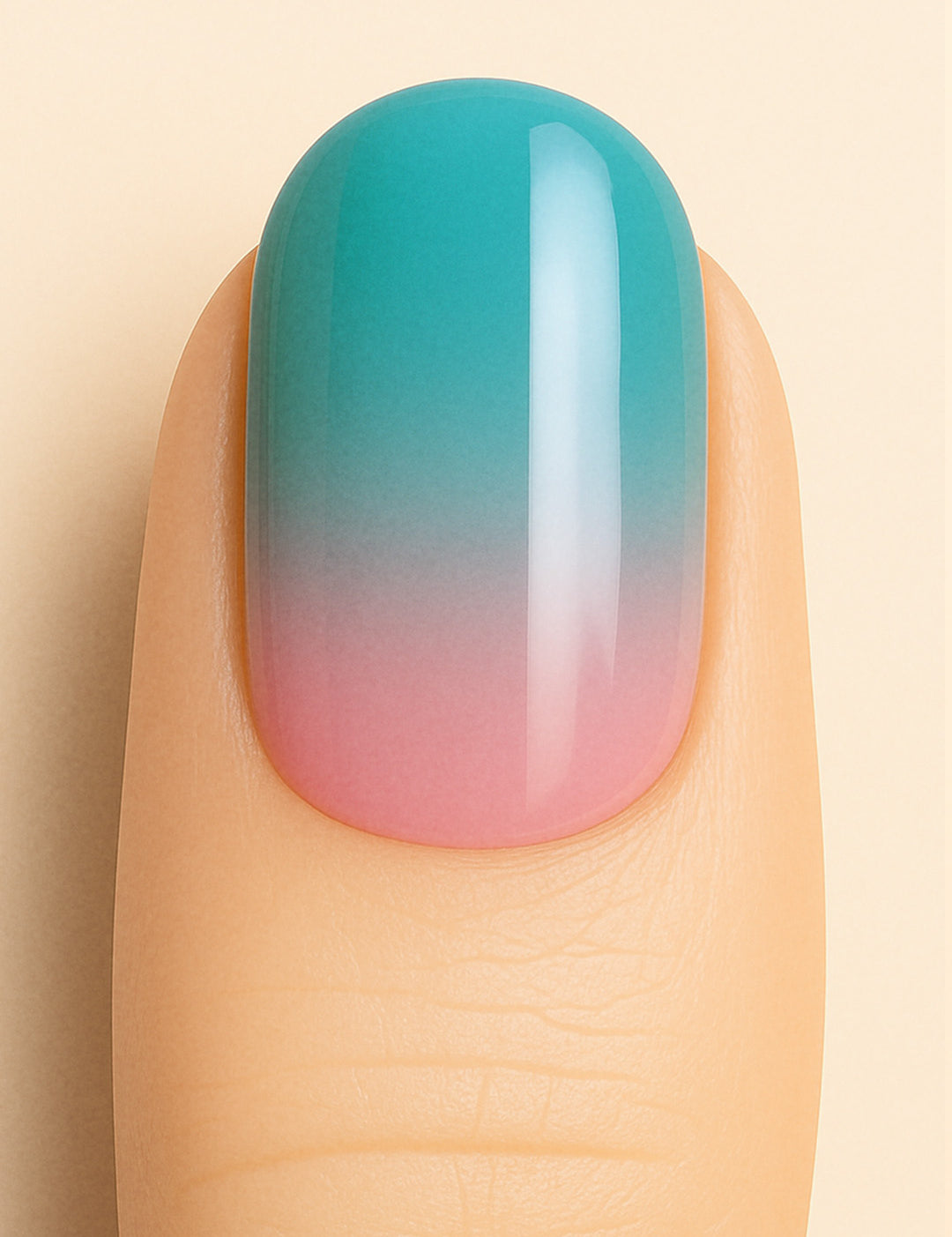 A close-up of a model’s finger wearing Ocean Sunset Ombre Nail Stickies, blending soft pink at the base into a serene teal blue at the tip, capturing a smooth glossy gradient that mirrors a tropical sunset sky – Muselot.
