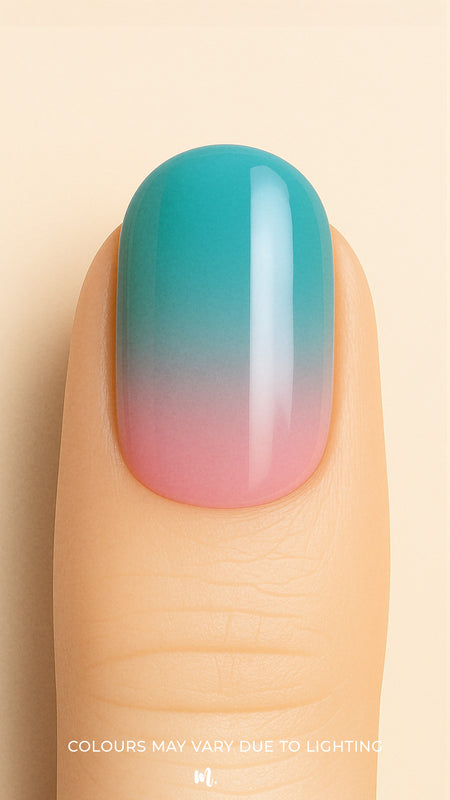 A close-up of a model’s finger wearing Ocean Sunset Ombre Nail Stickies, blending soft pink at the base into a serene teal blue at the tip, capturing a smooth glossy gradient that mirrors a tropical sunset sky – Muselot.