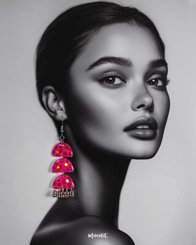 A woman wearing Parvaaz handmade pink drop earrings, styled with effortless charm to highlight their delicate craftsmanship and showcasing how these playful pieces add a soft, elegant touch to everyday or festive looks — Muselot.