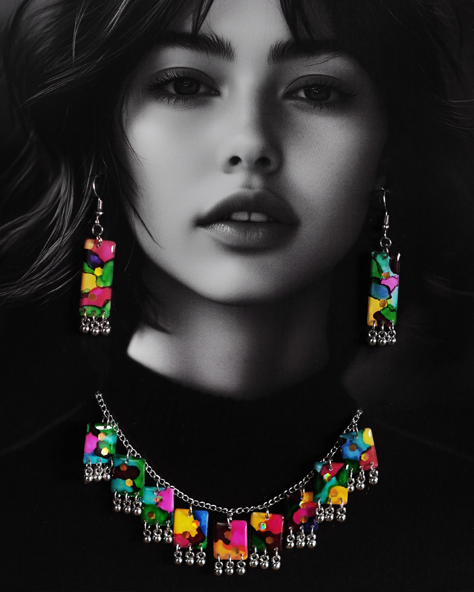 Close-up of a model wearing the Rangbaari colorful necklace set by Muselot, showcasing the vivid multicolor rectangular pendant pieces with silver ghungroos. The intricate blend of greens, pinks, blues, and yellows pops against the model’s skin, highlighting the festive, bohemian aesthetic of the jewelry.