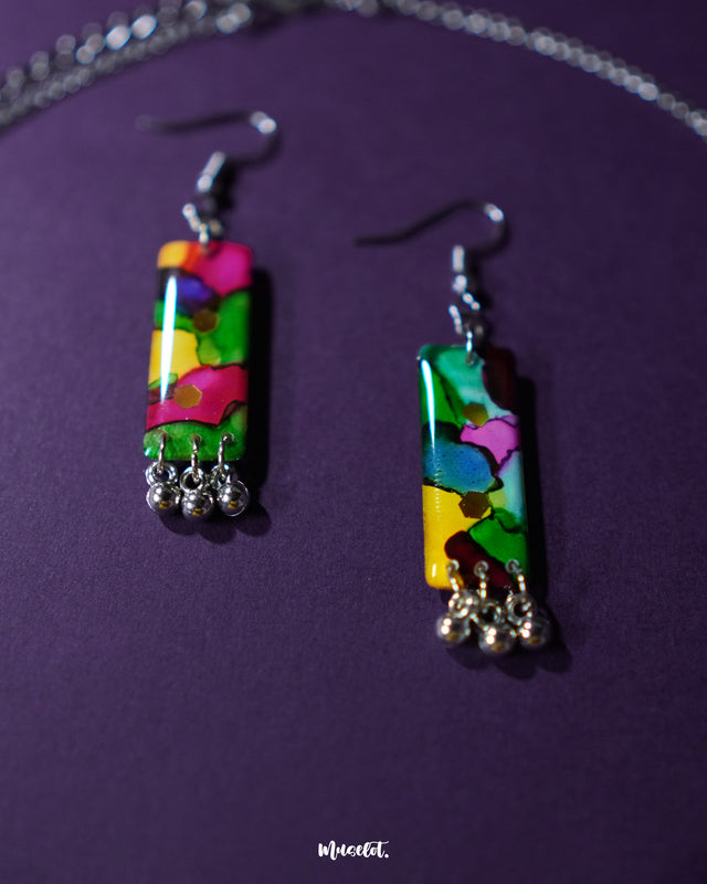 Rangbaari colorful earrings featuring vibrant multicolor abstract rectangular charms with silver bead accents, elegantly showcased to highlight their intricate design and lively hues – Muselot.