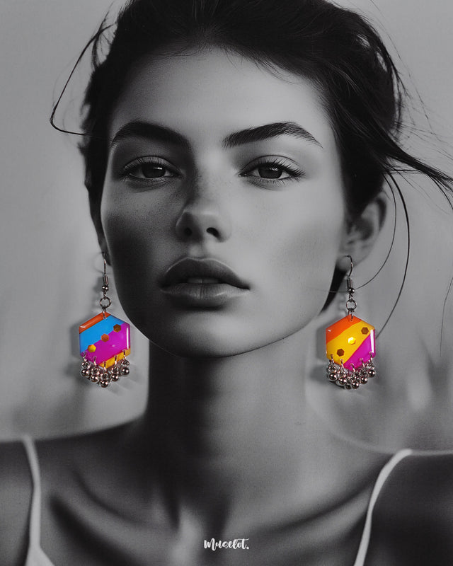 A model wears the Rangbahaar hook earrings, showcasing the vivid blend of orange, yellow, pink, and blue tones with shimmering sequins and playful metallic danglers, adding a bold and festive charm to her look — Muselot.