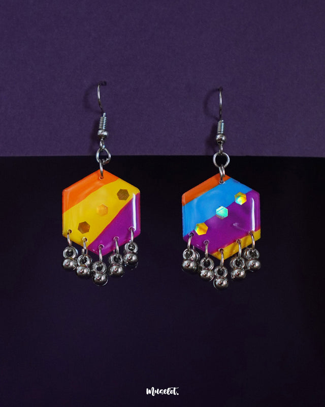 Rangbahaar hook earrings featuring asymmetrical hexagonal drops in vibrant orange, yellow, pink, and blue segments, adorned with glossy sequins and metallic jhumki-style danglers — Muselot.