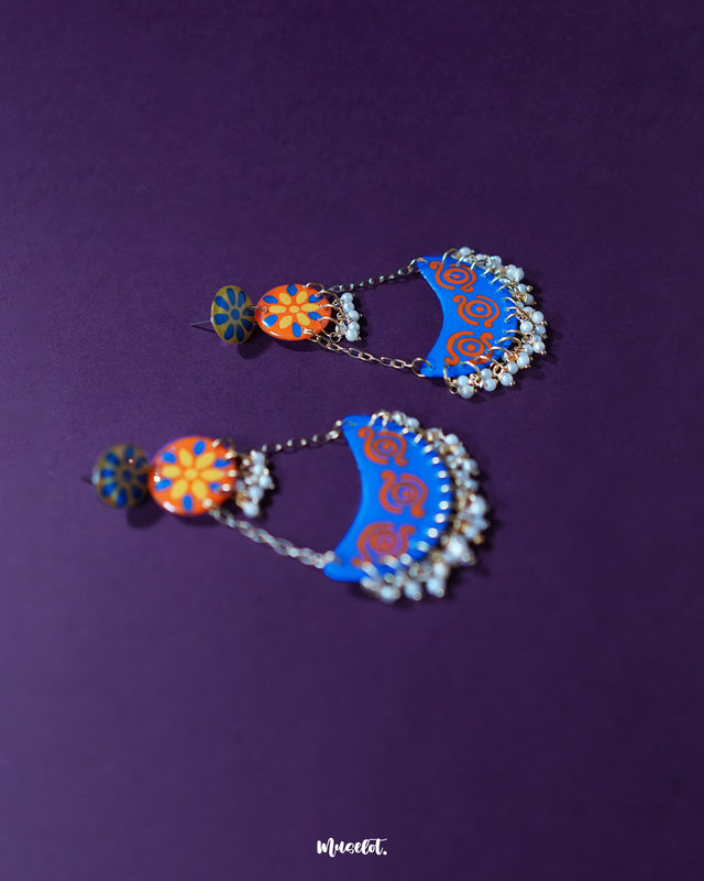 Ranglahar blue chandbaali earrings displayed against a soft backdrop, highlighting the intricate detailing, cool-toned enamel, and dangling pearls that reflect elegance in every curve — Muselot.