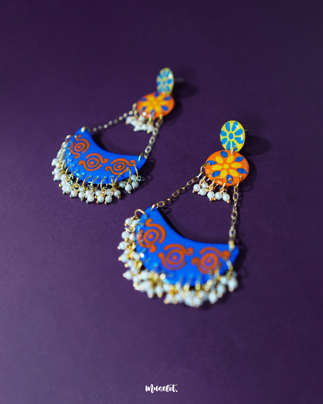Ranglahar blue chandbaali earrings showcasing a graceful crescent silhouette with intricate detailing and soft pearl embellishments, perfect for elevating festive looks — Muselot.