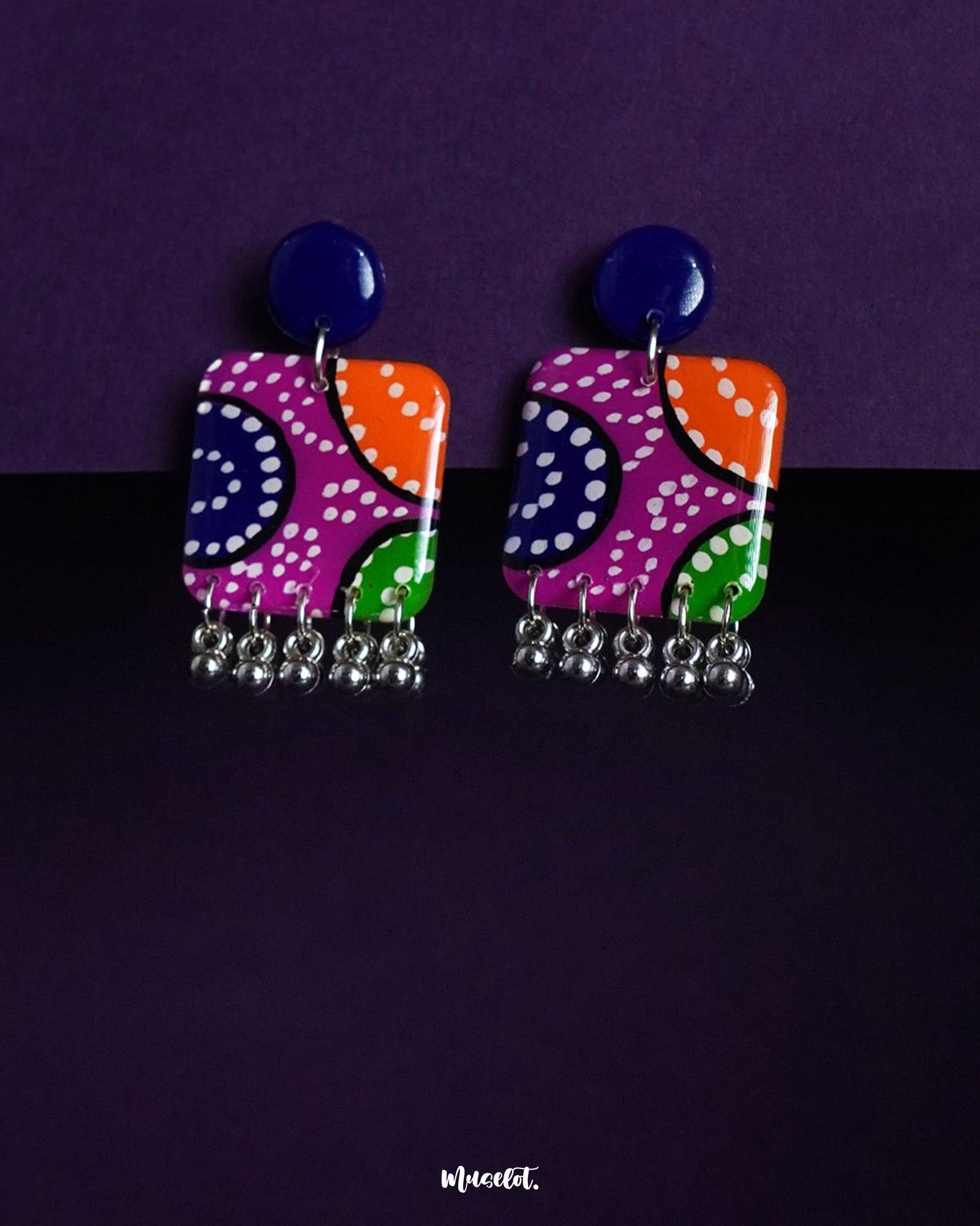 Rangras folk art stud earrings, set against a subtle background, featuring vibrant colors and intricate patterns that reflect the beauty of traditional folk art with a contemporary touch — Muselot.