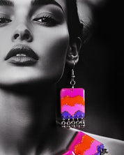 The model wears a vibrant earring from the Rangrezan handmade colorful necklace set, featuring multicolored beads and oxidized silver accents that add a playful yet traditional charm to the look — Muselot.