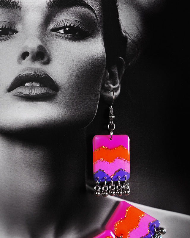 The model wears a vibrant earring from the Rangrezan handmade colorful necklace set, featuring multicolored beads and oxidized silver accents that add a playful yet traditional charm to the look — Muselot.