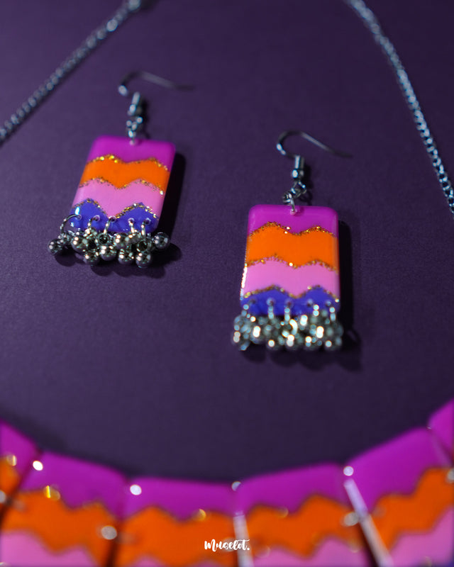 The Rangrezan handmade colorful necklace set features a striking blend of vibrant hues and detailed beadwork, making it a cheerful and eye-catching addition to festive and ethnic outfits — Muselot.