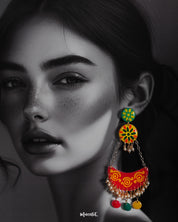 A woman wears the Rangsiya chandbali earrings, where vibrant colors meet artisanal flair — featuring hand-painted motifs, dainty pearls, and cheerful hanging discs that add a festive touch to any outfit — Muselot.
