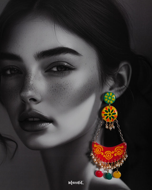 A woman wears the Rangsiya chandbali earrings, where vibrant colors meet artisanal flair — featuring hand-painted motifs, dainty pearls, and cheerful hanging discs that add a festive touch to any outfit — Muselot.