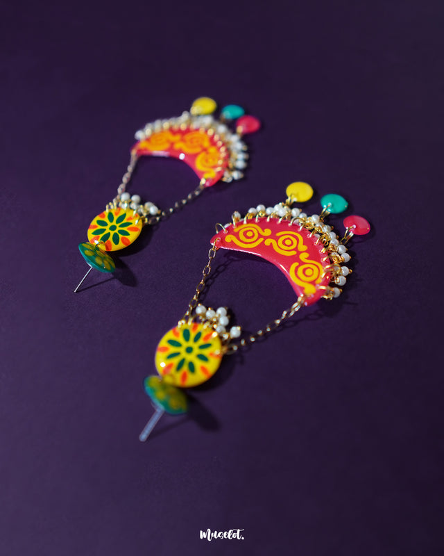 The Rangsiya colorful chandbali earrings are displayed against a soft backdrop, highlighting the blend of festive red, sunny yellow, and playful multicolor danglers, with pearl drops adding a touch of elegance — Muselot.