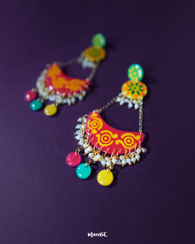 The vibrant Rangsiya chandbali earrings stand out with their bold fusion of colors and detailed motifs — accented with pearl danglers and antique-style metalwork that add depth and charm to every curve — Muselot.