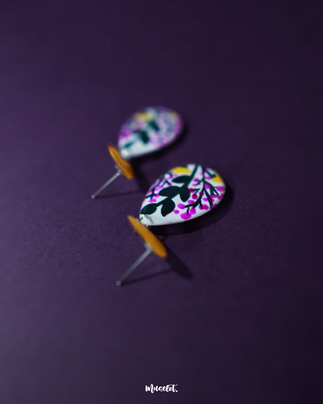 Raushanbahaar floral drop earrings in a teardrop shape, featuring delicate hand-painted blooms in pink and yellow with black detailing, highlighting festive charm and showcasing traditional craftsmanship with a modern twist — Muselot.