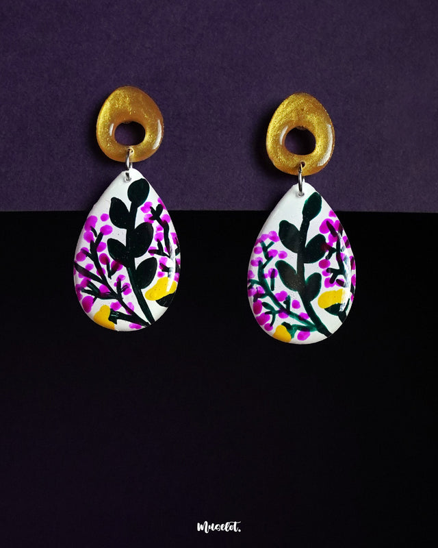 Raushanbahaar floral drop earrings in a teardrop shape, featuring intricate hand-painted pink and yellow blossoms with leafy motifs, highlighting vibrant elegance and showcasing the fusion of art and accessory — Muselot.