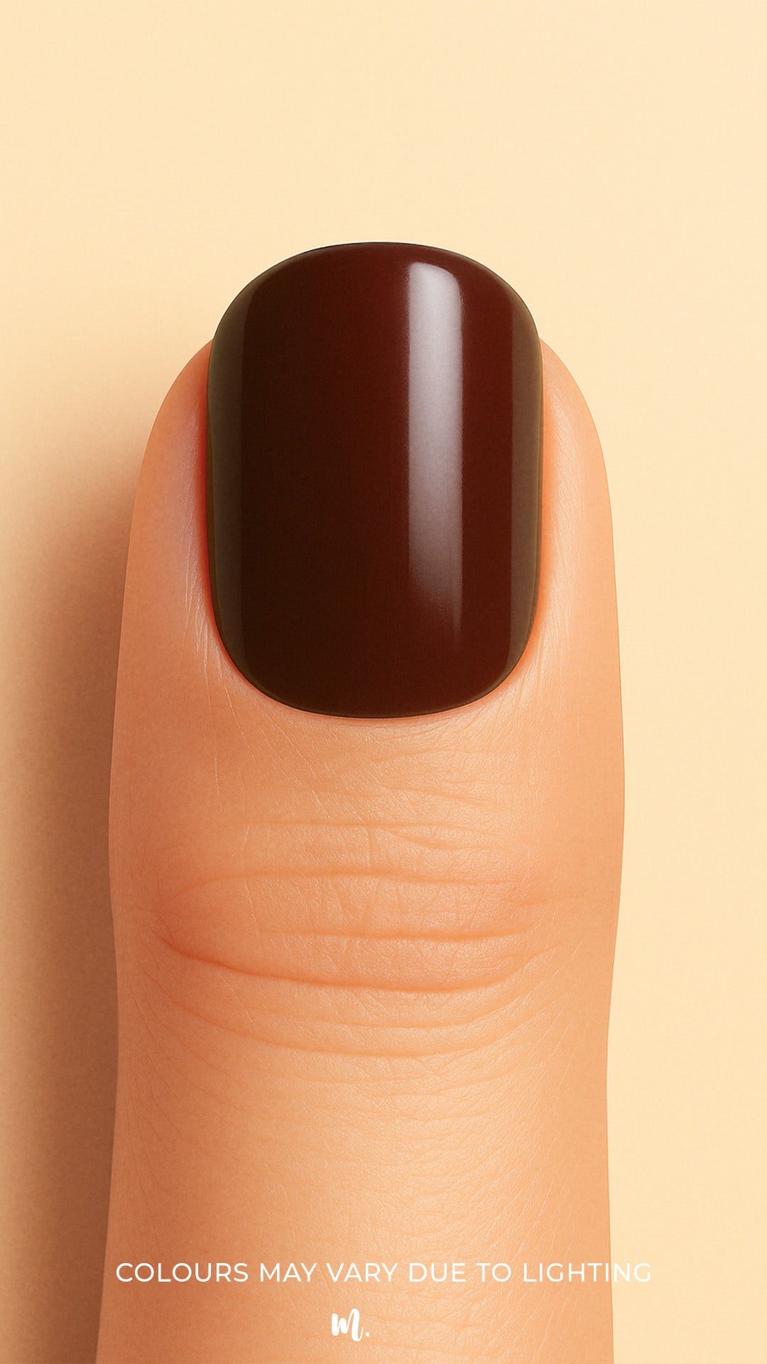 A close-up shot of a model finger wearing Rich Cocoa nail stickies, showcasing the deep chocolate-brown shade with a smooth glossy finish, highlighting the bold sophistication and elegance of minimal solid nail art – Muselot.