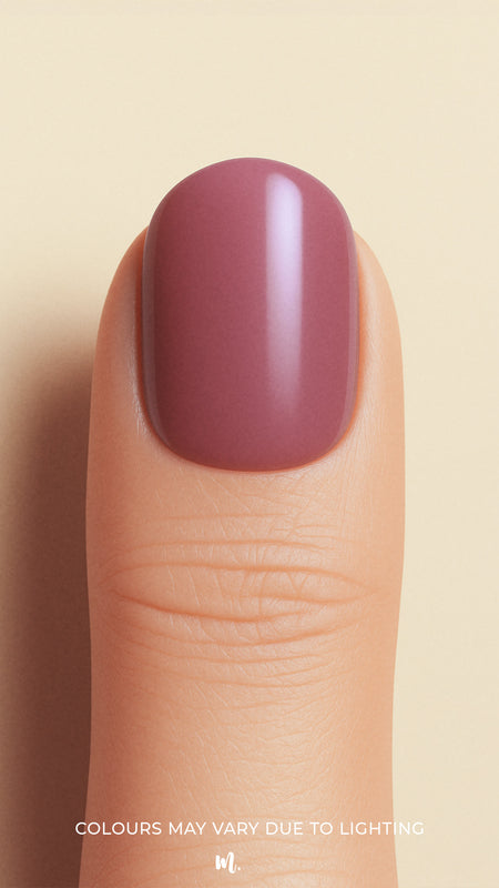 A closeup shot of a model thumb, showcasing a rich mauve shade with a glossy finish, highlighting the elegance of minimal solid color nails-Muselot