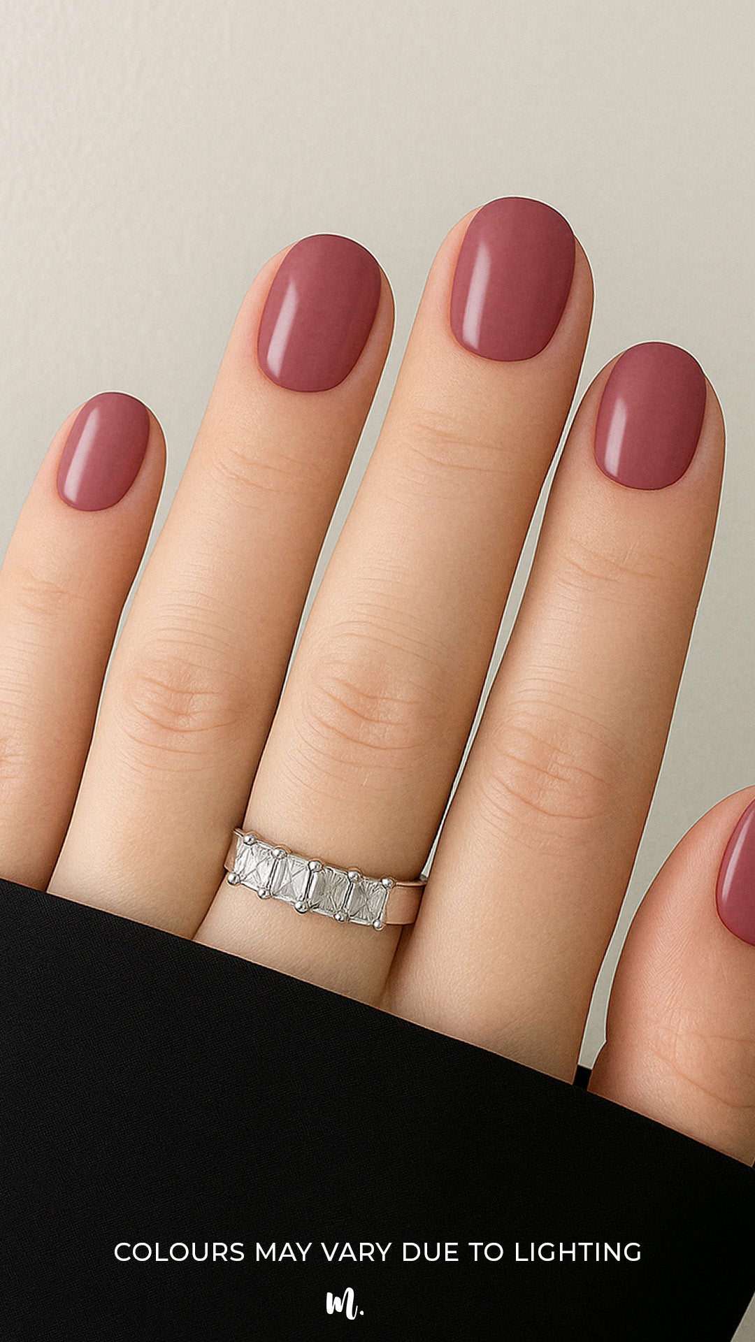 A shot of a model’s hand wearing Rose Clay nail stickies, showcasing the shade in a rich mauve tone with a glossy solid finish, highlighting the elegance of minimal nail art while adding a refined salon-style look – Muselot.