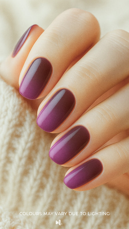 A model’s hand styled with Rosewood Ombre Nail Stickies, showcasing a seamless gradient from deep brown to plum across the nails, highlighting the bold richness and glossy elegance of this ombre nail art – Muselot.