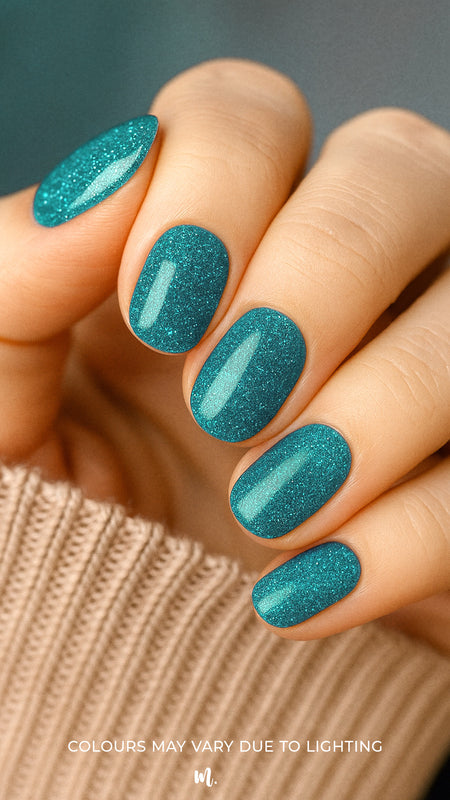 A model hand wearing Sea Spark Glitter nail stickies, showcasing the vibrant turquoise-blue shade with fine glitter shimmer, highlighting the bold sparkle and festive elegance of glitter nail art in a smooth, salon-style finish – Muselot.
