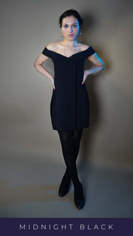 A woman standing with her legs crossed and her hands on her waist as she looks at the camera, wearing black stretchable stocking for girls, highlighting the smooth texture-Muselot