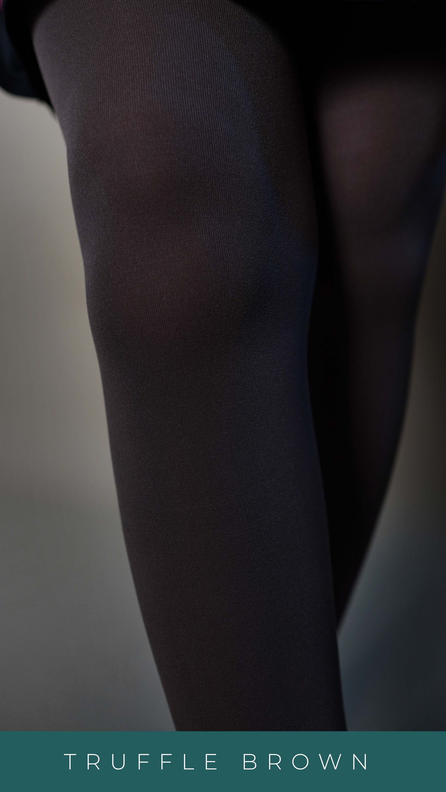 A close-up of the legs of a model standing against a grey background, wearing dark brown semi opaque tear proof stockings, highlighting its smooth durable tear resistant feature-Muselot