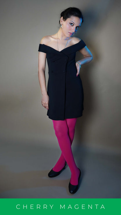 A woman wearing tear proof hot pink females stocking, posing with her hand hanging at her side and other on her waist as she stands with crossed legs, highlighting the relaxed modern look-Muselot