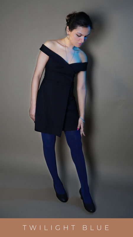 A woman posing with her leg stretch as if she is walking, her hand reaching to touch the side of her thigh as she bends slightly forward looking at her thigh, showcasing the smooth durable material-Muselot