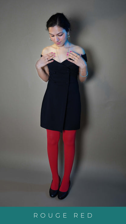 A woman wearing semi opaque multi colored females tights, posing with her hand toching her neck as she looks down at her stockings, highlighting the perfect trendy look-Muselot