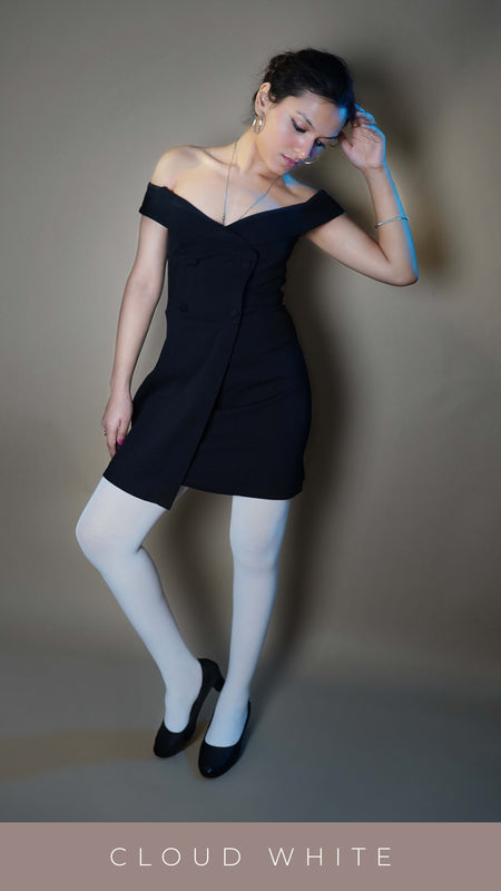 A woman wearing plus size white tear proof stocking, posing with her hand touching the side of her head as she bends slightly to her side looking at the ground, showcasing the comfortable stretchable material-Muselot