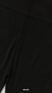 Close-up of semi-opaque black tights fabric with reinforced stitching, showcasing durability, smooth texture, and high-quality finish - Muselot