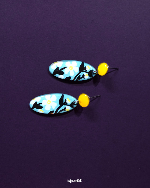 Close-up view of Shaamgul drop earrings capturing the delicate floral motifs and dangling bead accents, highlighting the artisanal detailing and elegant craftsmanship — Muselot.
