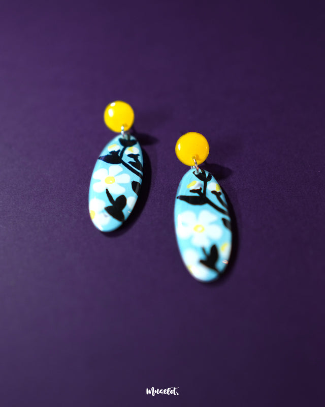 Shaamgul drop earrings displayed on a soft background, showcasing their handcrafted floral design with muted tones and intricate beadwork that reflects traditional charm — Muselot.
